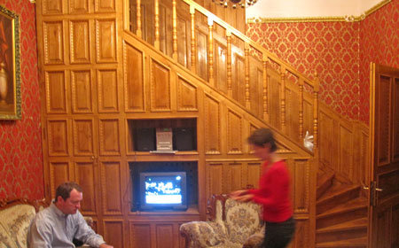 walk up these stairs three floors to an oversize wood door covered with varnished strips of white oak and into this room